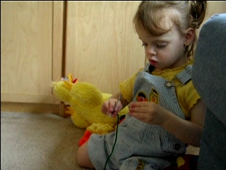 Peo puts noodles on string.