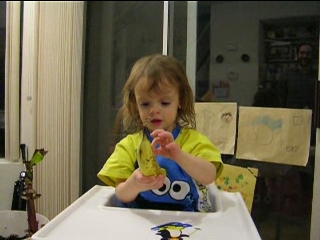 Peo playing with a banana with eyes.